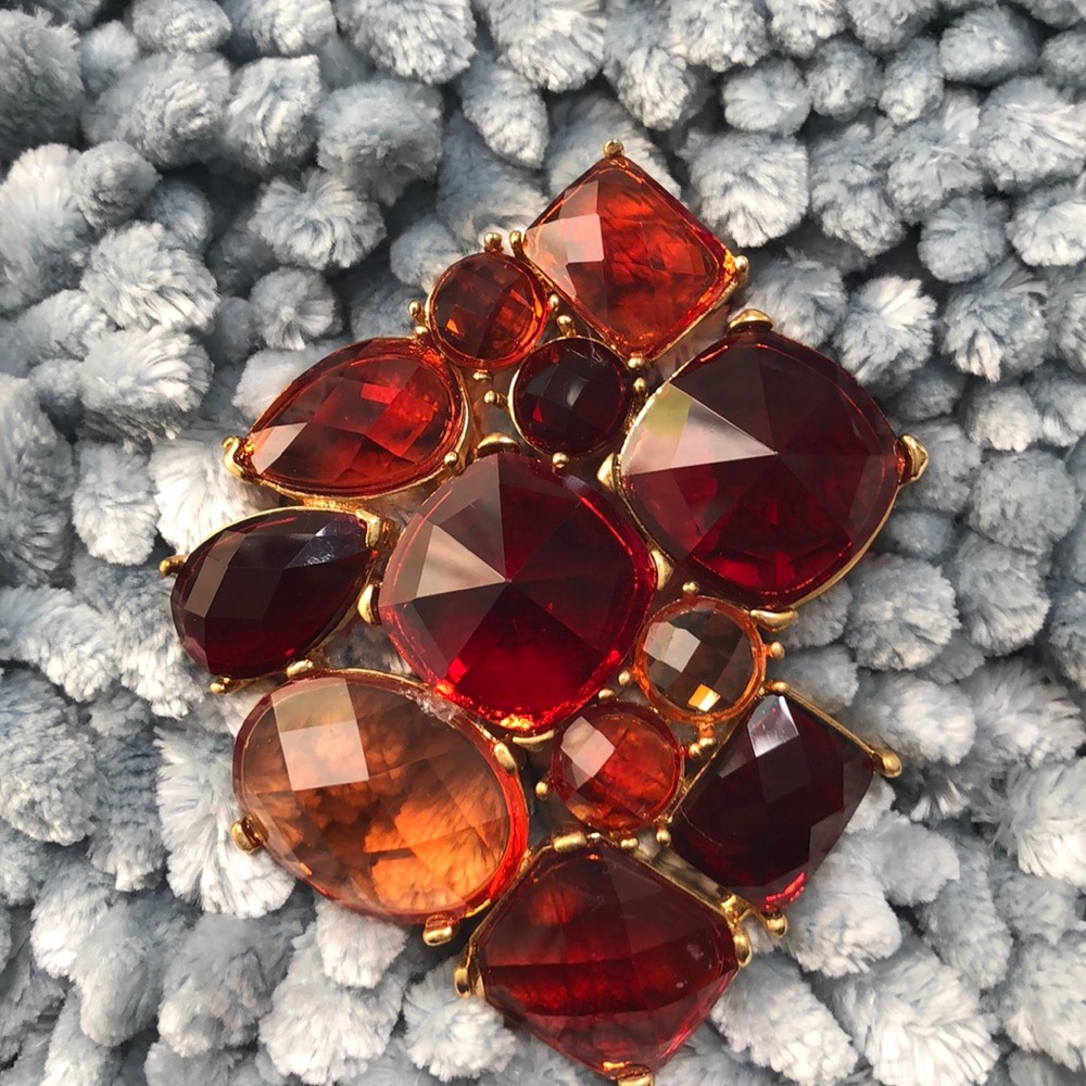 Red and cream stones in gold pendant